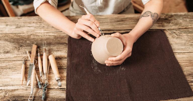 A person making home made pottery by hand