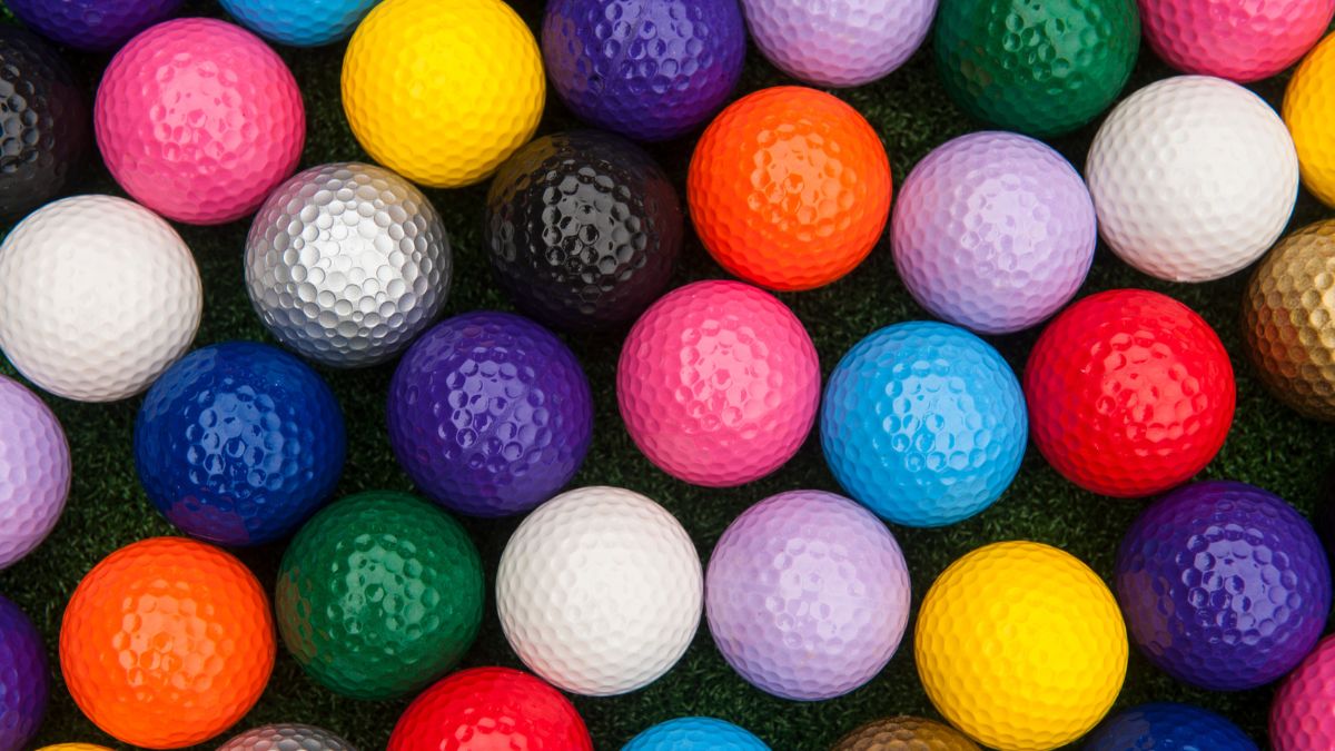 Colorful mini golf balls ready to play at an outdoor course