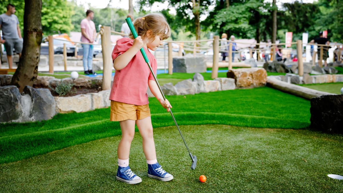Family playing mini golf together on Cape Cod
