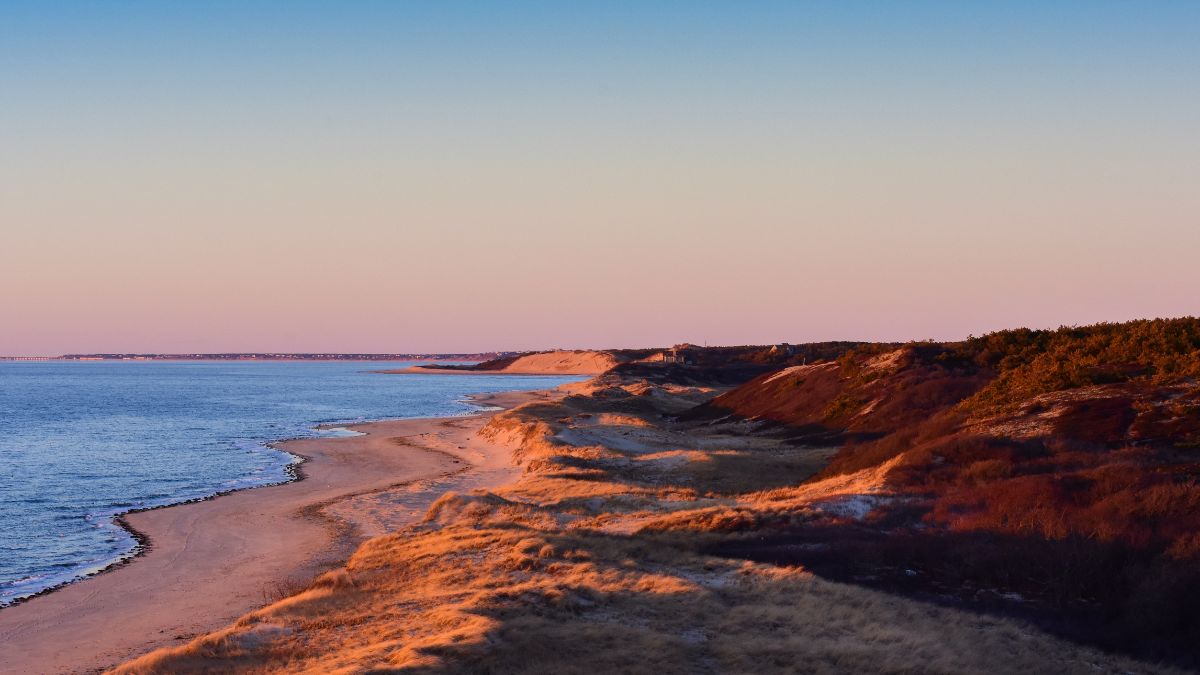 View of the Cape Cod National Seashore ocean and dunes at sunset.