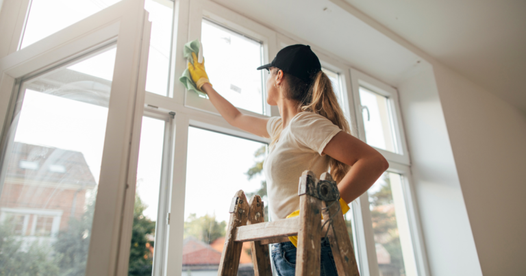 woman cleaning windows in home