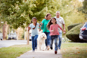 family on a walk in suburban neighborhood