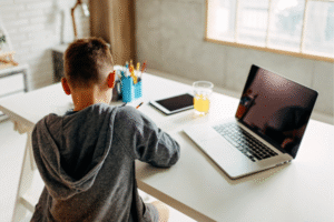 Child doing homework in their designated homework corner in home