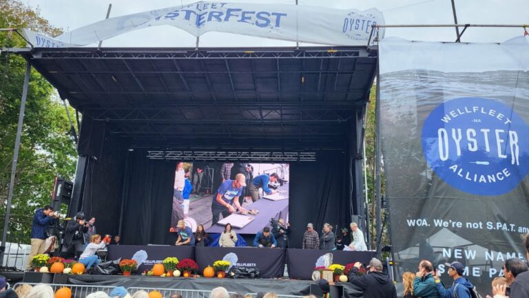 Wellfleet OysterFest stage and oyster-shucking contest on Cape Cod