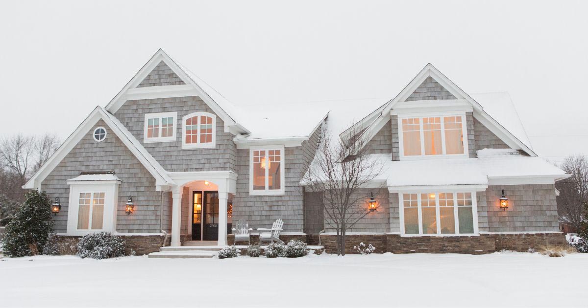 Shingle-style coastal home in Massachusetts during winter, showing rooflines, windows, and exterior condition.