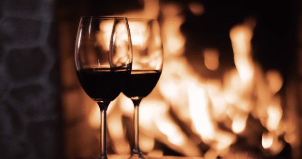 Wine glasses by a fireplace in a cozy restaurant