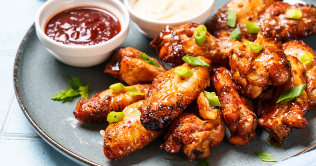 Freshly made, crispy buffalo chicken wings on restaurant platter