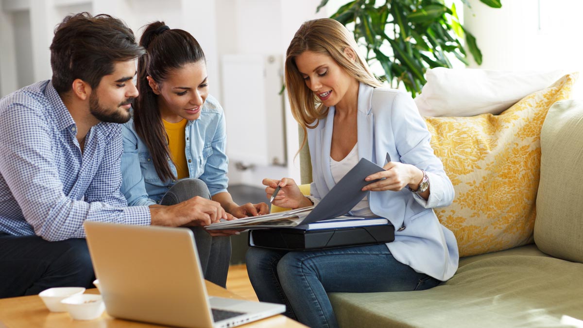 Real estate agent talking with homeowners about their home's market value