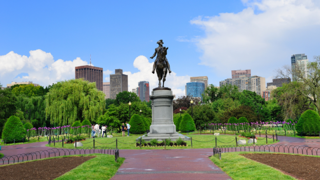 Boston Public Garden walking paths and skyline view with statue