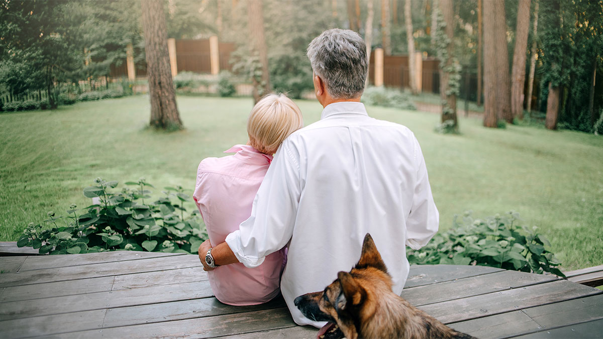 couple sitting on deck with dog reflecting on their next chapter at home