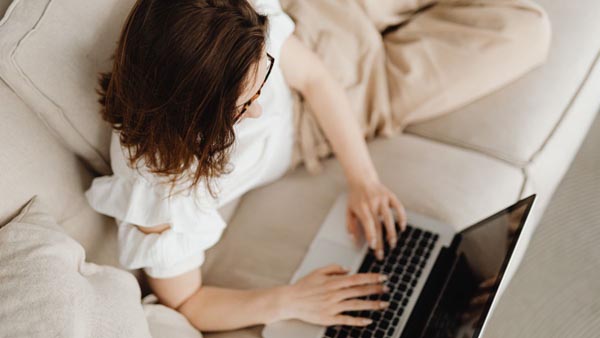 Person researching real estate online from home using a laptop