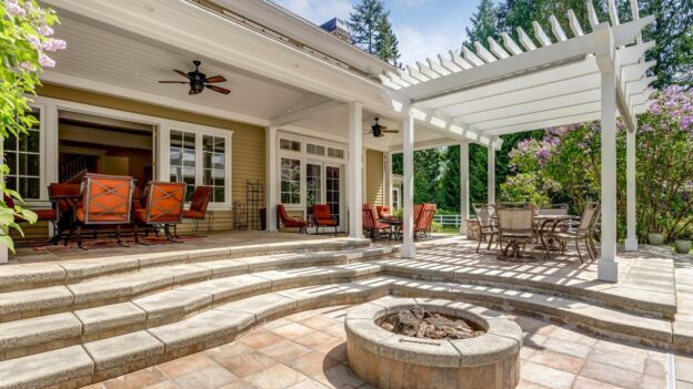 Outdoor patio with pergola, fire pit, and seating area