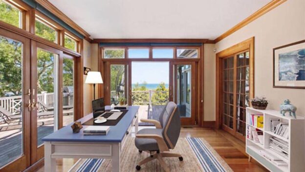 Light-filled coastal home office with water views and access to an outdoor deck