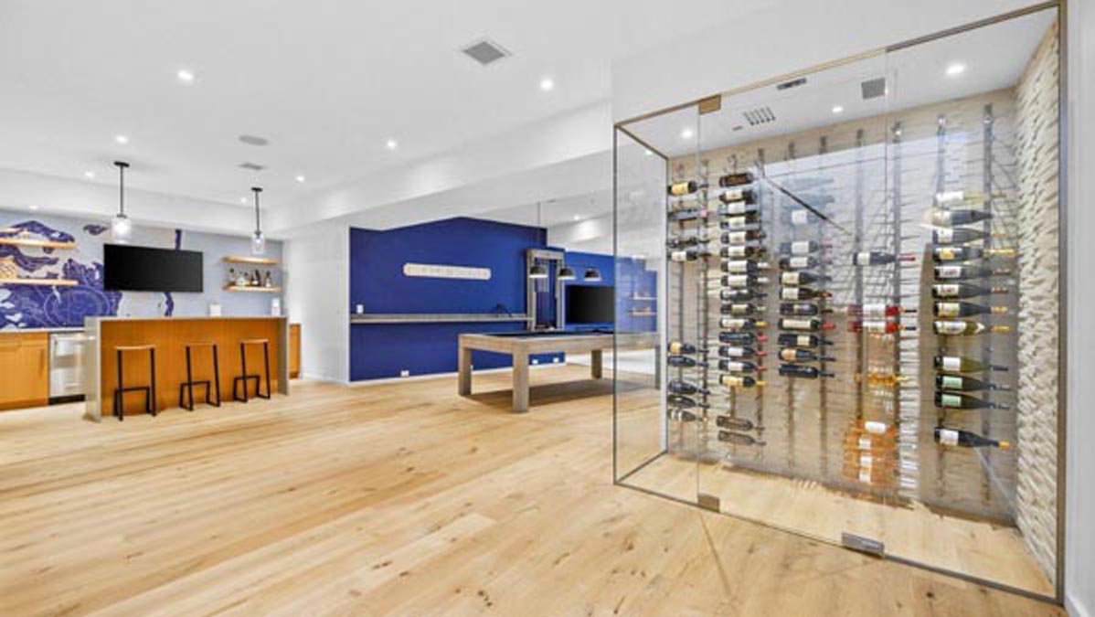 Finished lower level with a lounge, billiards area, bar, and wine storage
