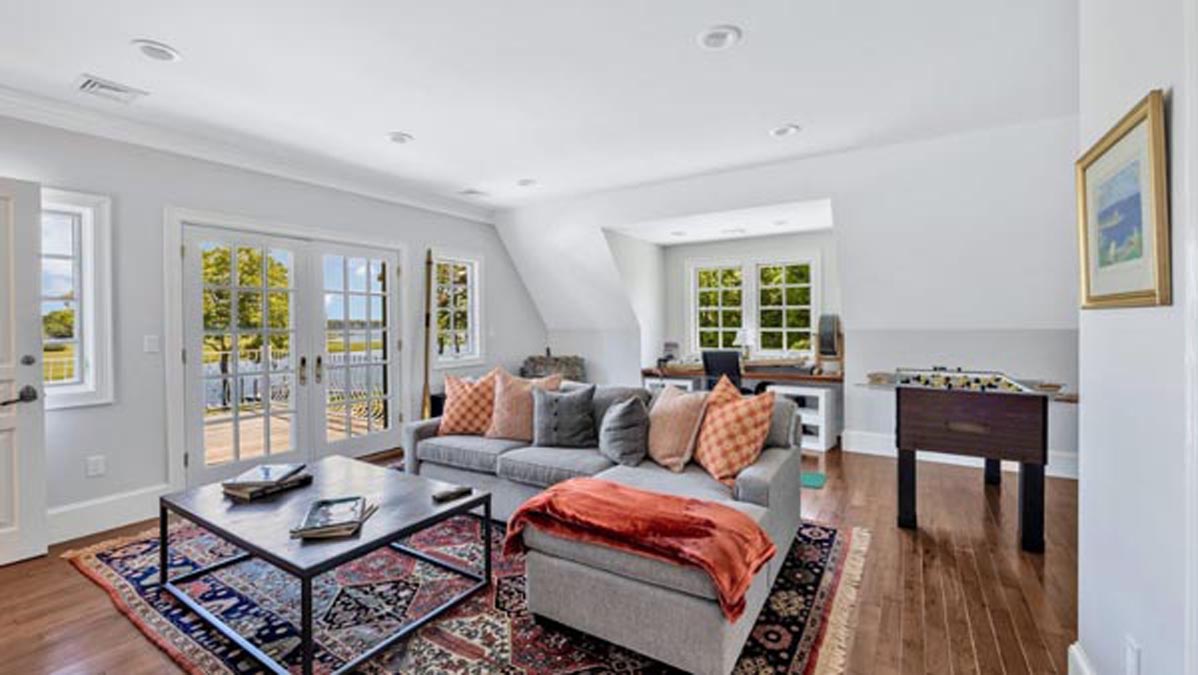 Flexible bonus room with lounge seating, a game table, and access to an outdoor deck