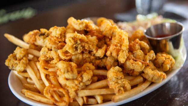 Fried seafood platter with fried clams and french fries