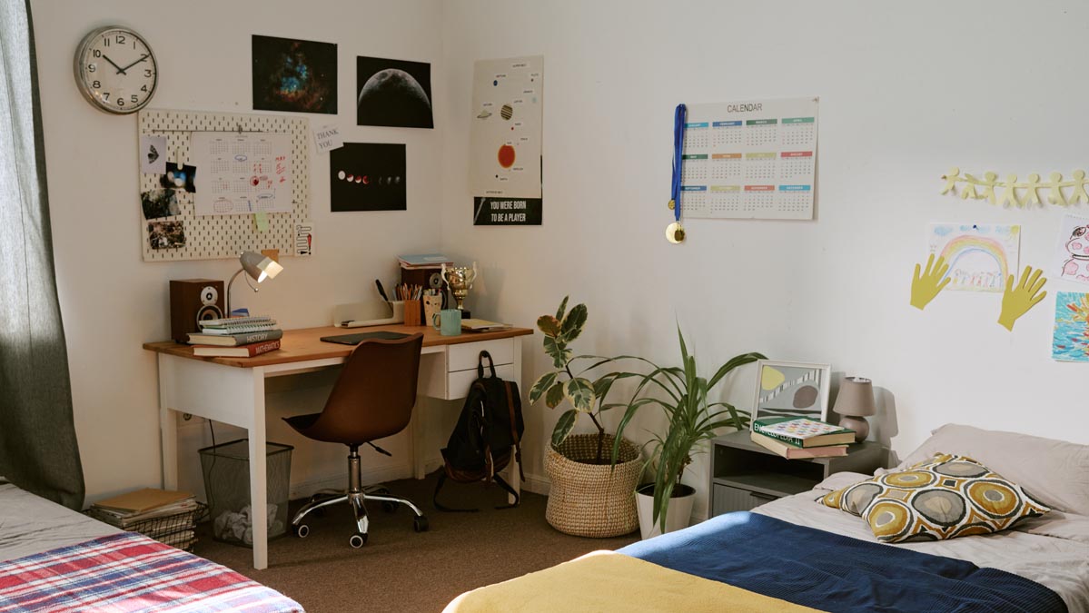 Bedroom with organized study desk and calendar for the school year