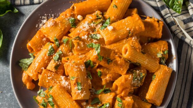 Rigatoni pasta tossed in a creamy tomato sauce with herbs and grated cheese